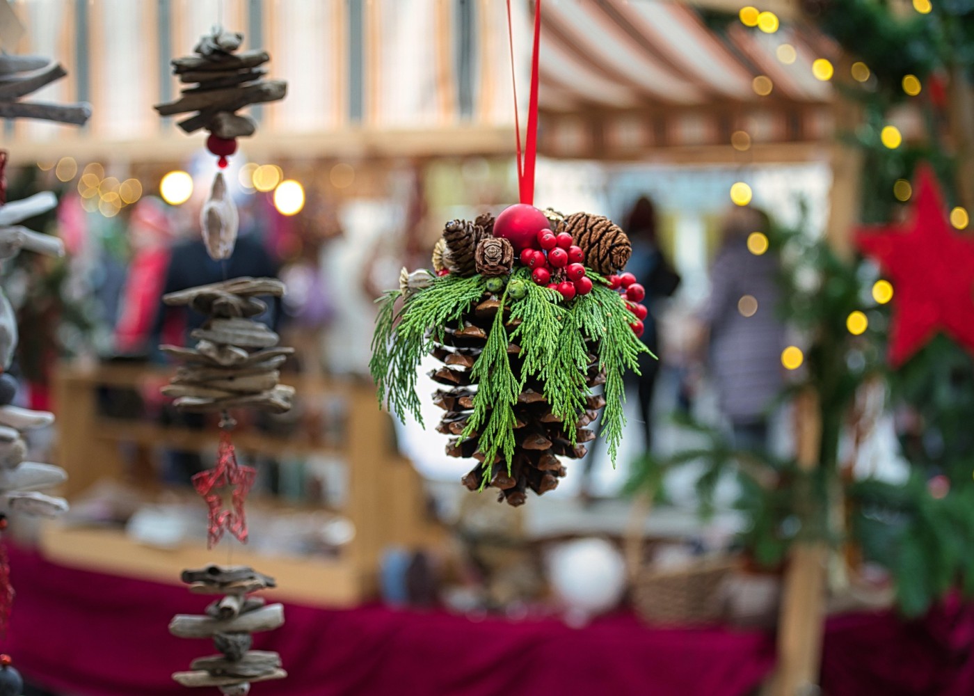 Geschmückter Tannenzapfen auf einem Weihnachtsmarkt.
